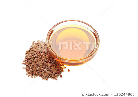 Flaxseeds with flaxseed oil in bowl isolated on white background. 126244905