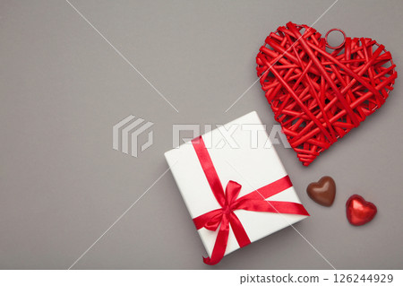 Valentine's day greeting card with gift, hearts chocolate sweets on grey background. 126244929