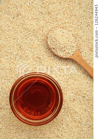 Sesame seeds in spoon and sesame oil. Vertical photo 126244943
