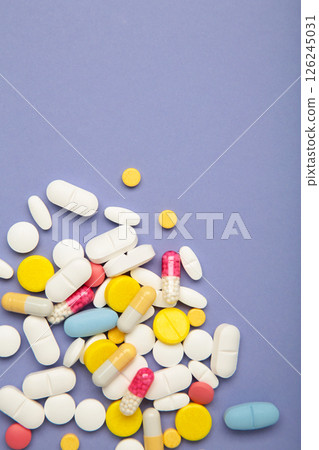 Various colored pills on purple background. Space for text Various colored pills on purple background. Space for text 126245031