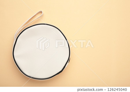 White leather cosmetic bag without logo, mockup on beige background White leather cosmetic bag without logo, mockup on beige background 126245040