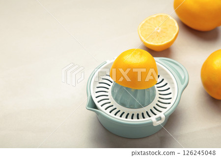 Squeezer and lemons on light background. Space for text 126245048