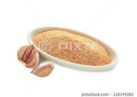 Garlic powder on plate isolated on white background, top view Garlic powder on plate isolated on white background, top view 126245062