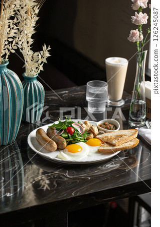 Breakfast with sausages and fried eggs Breakfast with sausages and fried eggs 126245087