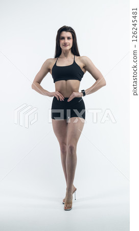 Young beautiful woman with athletic body on white background. Fitness girl Young beautiful woman with athletic body on white background. Fitness girl 126245481