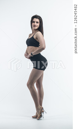 Young beautiful woman with athletic body on white background. Fitness girl 126245482