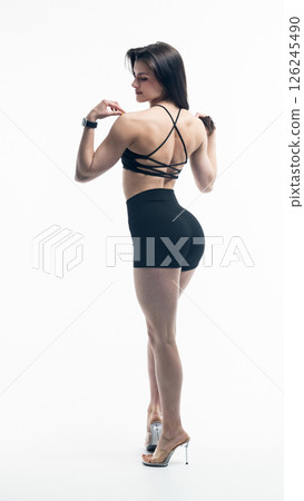 Young beautiful woman with athletic body on white background. Fitness girl Young beautiful woman with athletic body on white background. Fitness girl 126245490