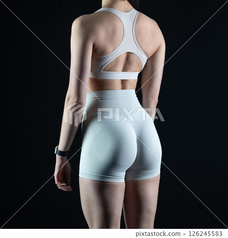 athletic female body on dark background, fitness woman, athletic girl torso 126245583