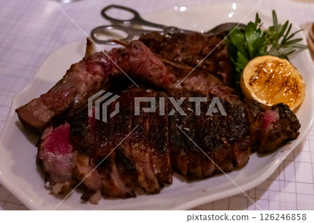 Medium rare meat steak on wooden plate Medium rare meat steak on wooden plate 126246858