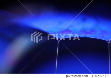 Deep purple liquid surface on black background, oil stains movement, bright chemistry, deep space background 126247516
