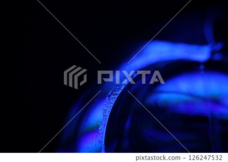 Deep purple liquid surface on black background, oil stains movement, bright chemistry, deep space background 126247532