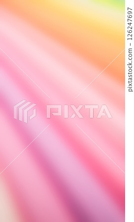 a soft, dreamy blur of pastel colors, primarily pinks, oranges, and hints of yellow and green, with diagonal movement 126247697