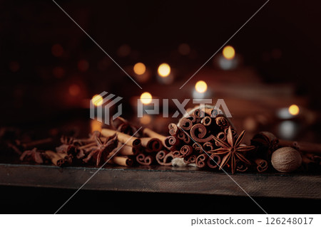 Cinnamon sticks, anise, and nutmeg on a old wooden table. 126248017
