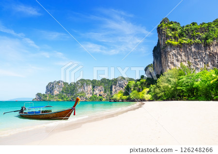 Thai traditional wooden longtail boat and beautiful white sand Railay Beach in Krabi province, Ao Nang, Thailand. 126248266