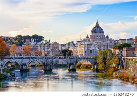 Beautiful autumn image of St. Peter's Basilica, Ponte Sant Angelo and Tiber River at dusk in Rome, Italy. Beautiful autumn image of St. Peter's Basilica, Ponte Sant Angelo and Tiber River at dusk in Rome, Italy. 126248270