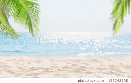 Seascape with tropical white sand beach, palm tree leaves and blur bokeh light of sea and sky. Summer vacation background concept. 126248308