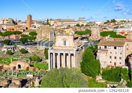 Ruins of the Roman Forum and the Temple of Antoninus and Faustina in the center, with the cityscape of Rome, Italy in the background. Ruins of the Roman Forum and the Temple of Antoninus and Faustina in the center, with the cityscape of Rome, Italy in the background. 126248316