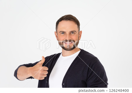 Young handsome man wearing in casual clothes doing happy thumbs up gesture with hand. Young handsome man wearing in casual clothes doing happy thumbs up gesture with hand. 126248400