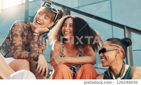 Laughing, fashion and friends in city on steps in cool clothes, casual outfit or modern style. Relax, talking or trendy women with smile in urban town for holiday, streetwear or vacation together 126248630