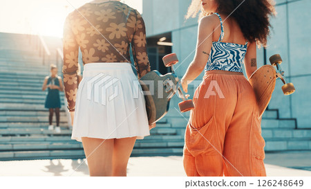 Skateboard, back and travel with friends in city for gen z youth, streetwear fashion and trendy style. Fitness, energy and social with women walking in street for urban, hobby and people together 126248649