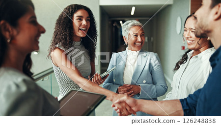 Smile, business and handshake with people in office for welcome, greeting and introduction at convention. Happy, woman and man shaking hands with partnership, agreement and congratulations of seminar Smile, business and handshake with people in office for welcome, greeting and introduction at convention. Happy, woman and man shaking hands with partnership, agreement and congratulations of seminar 126248838