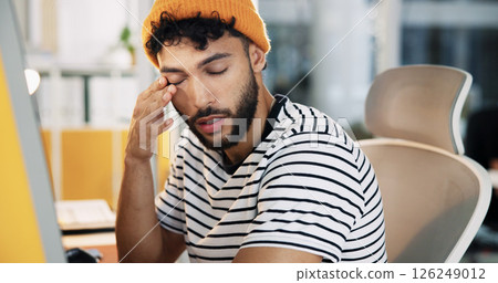 Creative, tired and man with burnout in office for web development deadline, overworked and brain fog. Designer, employee and exhausted at agency for website testing crisis, overwhelmed or eye strain 126249012