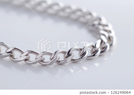 Shiny silver chain detail showcasing elegance and luxury with a contemporary stylish look. Ideal for fashion or jewelry concepts. Shiny silver chain detail showcasing elegance and luxury with a contemporary stylish look. Ideal for fashion or jewelry concepts. 126249064