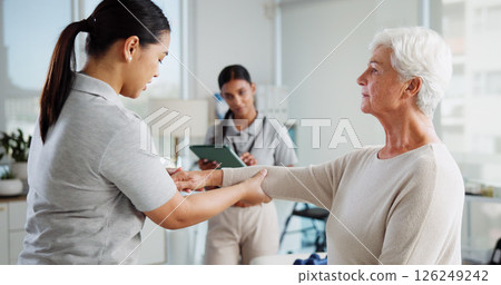 Physiotherapy, consulting and healthcare with old woman and doctor for rehabilitation, osteoporosis or medical. Physical therapy, help and advice with people in clinic for healing and orthopedic exam 126249242