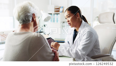 Tablet, doctor and conversation with patient for healthcare report, test results or help. Medical professional, tech and consultation with senior woman for checkup, questions or symptoms in hospital 126249532