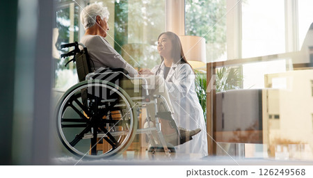 Women, caregiver and senior patient in wheelchair at retirement home for healthcare, support and checkup. Doctor, person with a disability and empathy for medical service, physiotherapy and care Women, caregiver and senior patient in wheelchair at retirement home for healthcare, support and checkup. Doctor, person with a disability and empathy for medical service, physiotherapy and care 126249568