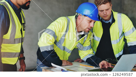 Man, laptop and group at construction site with meeting, review and planning for renovation project. Lead engineer, checklist and staff for documents, computer and blueprint for property development 126249587