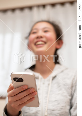 A girl watching a smartphone 126249668