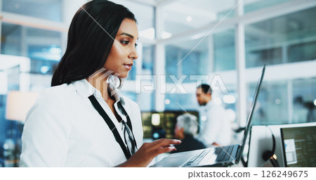Woman, developer and reading on laptop in office of programming, coding support and server update. Person, online app and IT for testing system, website application and troubleshooting at call centre 126249675
