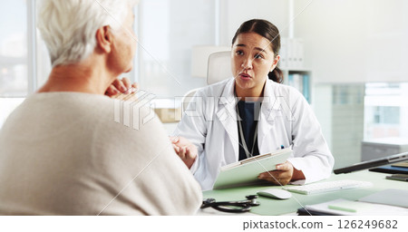 Senior woman, doctor and consultation with clipboard for healthcare report, symptoms or checkup. Medical professional, appointment and talk to patient for help with insurance application in hospital Senior woman, doctor and consultation with clipboard for healthcare report, symptoms or checkup. Medical professional, appointment and talk to patient for help with insurance application in hospital 126249682