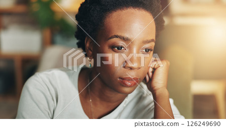 Memory, thinking and quiet with black woman in living room of home for daydreaming or nostalgia. Ideas, planning and vision with thoughtful African person in apartment for relaxing or wellness 126249690