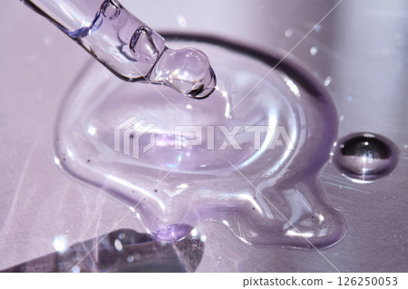 Pipette with serum on purple background with sunlight. 126250053
