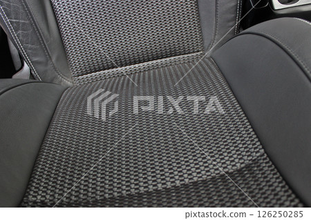 The backrest of the driver's seat in a car with different trim materials 126250285