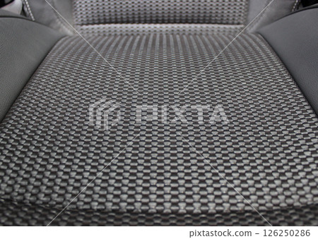 Intricate tape weave upholstery pattern of seat inside modern car Intricate tape weave upholstery pattern of seat inside modern car 126250286
