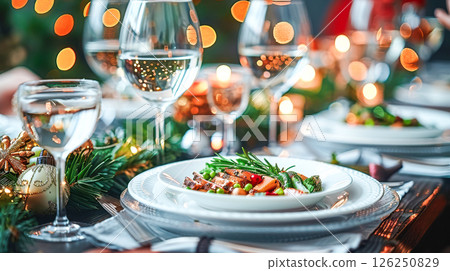 Still life served festive dinner table while Christmas lights glowing 126250829