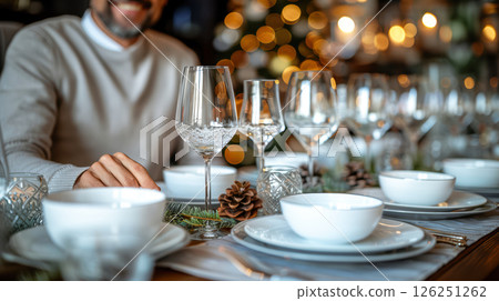 Still life served festive dinner table while Christmas lights glowing 126251262