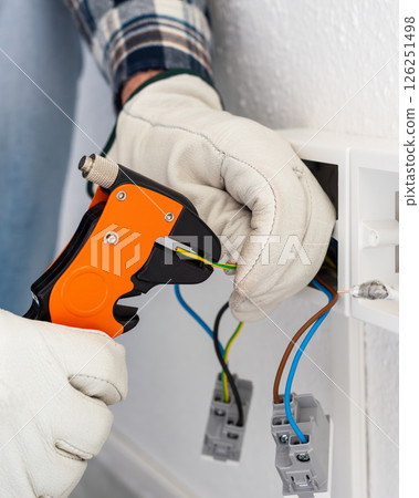 Electrician at work on a residential electrical system. Electricity. Electrician at work on a residential electrical system. Electricity. 126251498