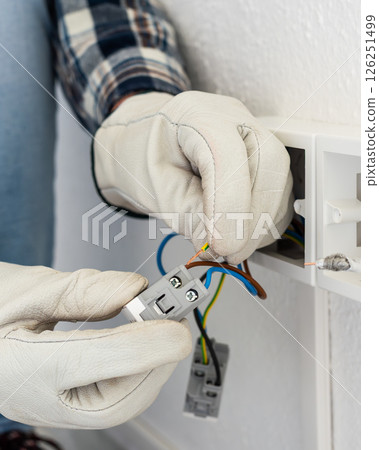 Electrician at work on a residential electrical system. Electricity. 126251499