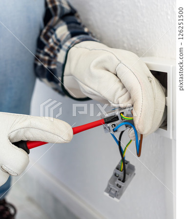 Electrician at work on a residential electrical system. Electricity. 126251500