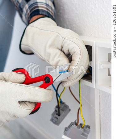 Electrician at work on a residential electrical system. Electricity. 126251501