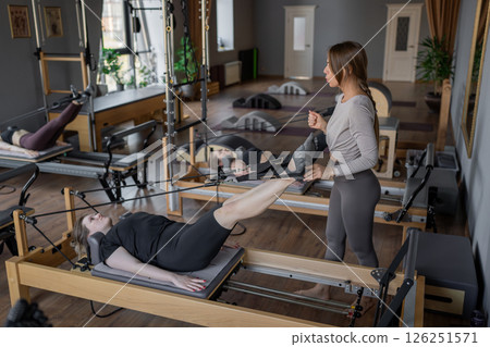 A detailed closeup of a foot work and core exercise on a Balanced Body Reformer machine illuminated by sunlight 126251571