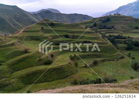 Chokhsky terraces Dagestan. Landscape of mountainous Dagestan with terraced fields and peaks mountains in the distance. Chokhsky terraces Dagestan. Landscape of mountainous Dagestan with terraced fields and peaks mountains in the distance. 126251614