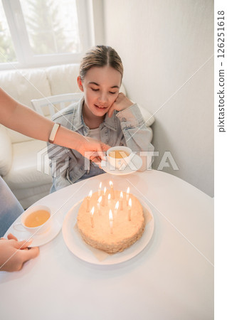 Birthday Cake Candles Girl - Celebration of a girl's birthday with a cake and lit candles. 126251618