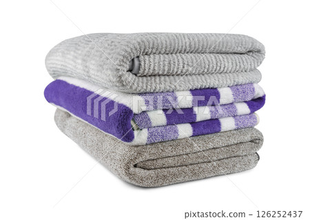 Soft fluffy striped grey and purple bath towels folded in stack isolated on white background Soft fluffy striped grey and purple bath towels folded in stack isolated on white background 126252437