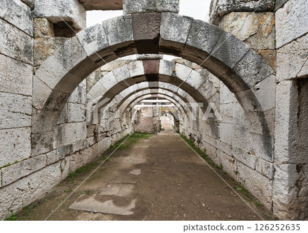 Exploring the ancient arches of Agora of Smyrna in Izmir, Turkey during sunset 126252635