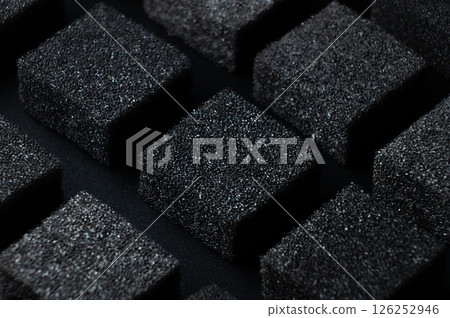 Black Cubes of flexible foam sponges laid out in a pattern. Macro close-up in soft focus. Abstract cubic background 126252946